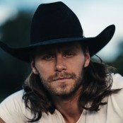 Warren Zeiders wearing a white tshirt and black cowboy hat\